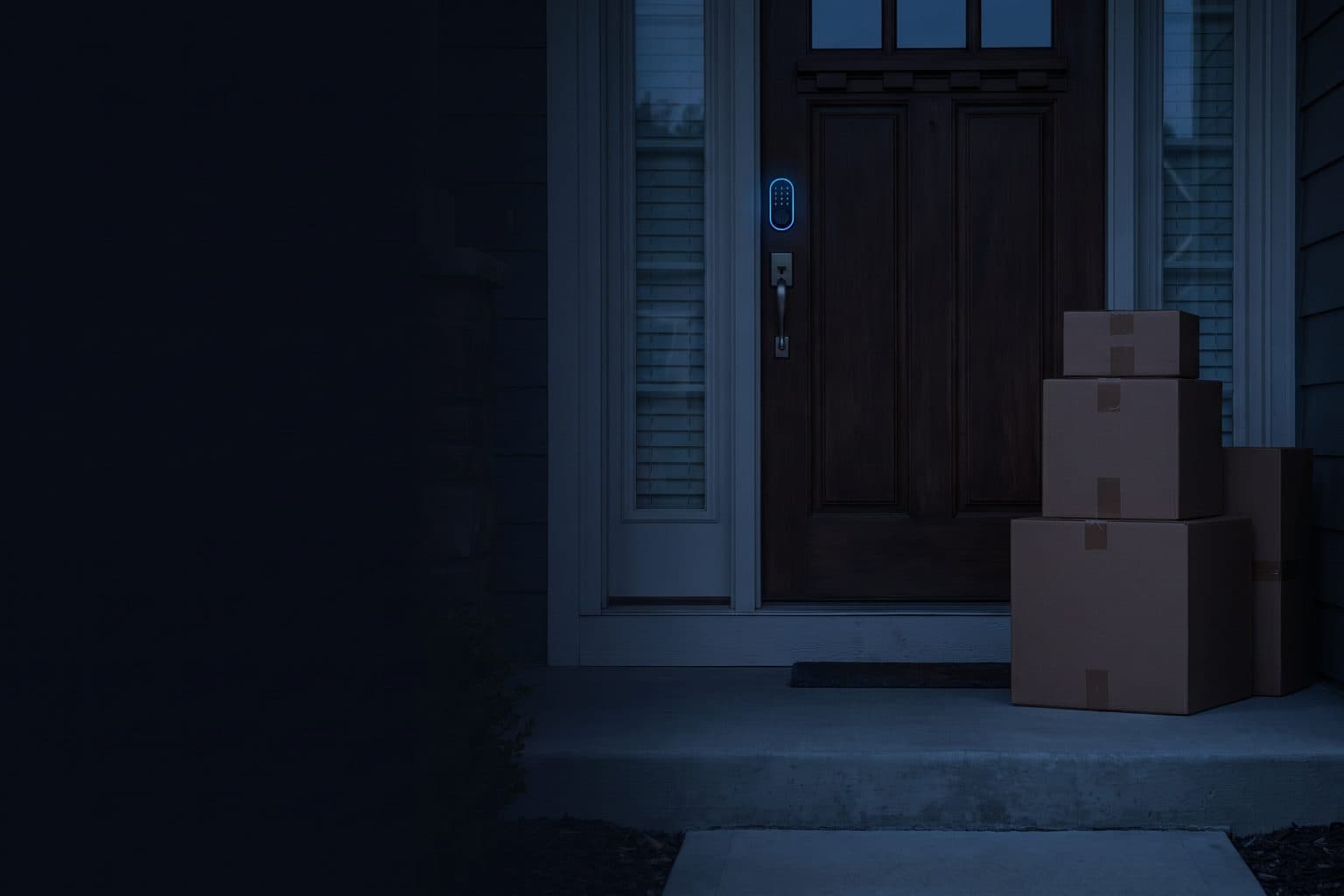 A front door at dusk with moving boxes stacked on the porch and a keypad lock glowing blue beside the handle